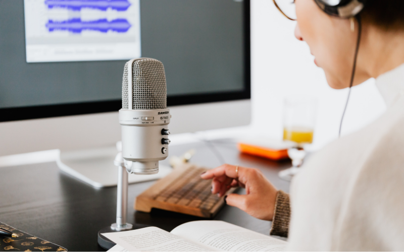 Person Speaking into Microphone